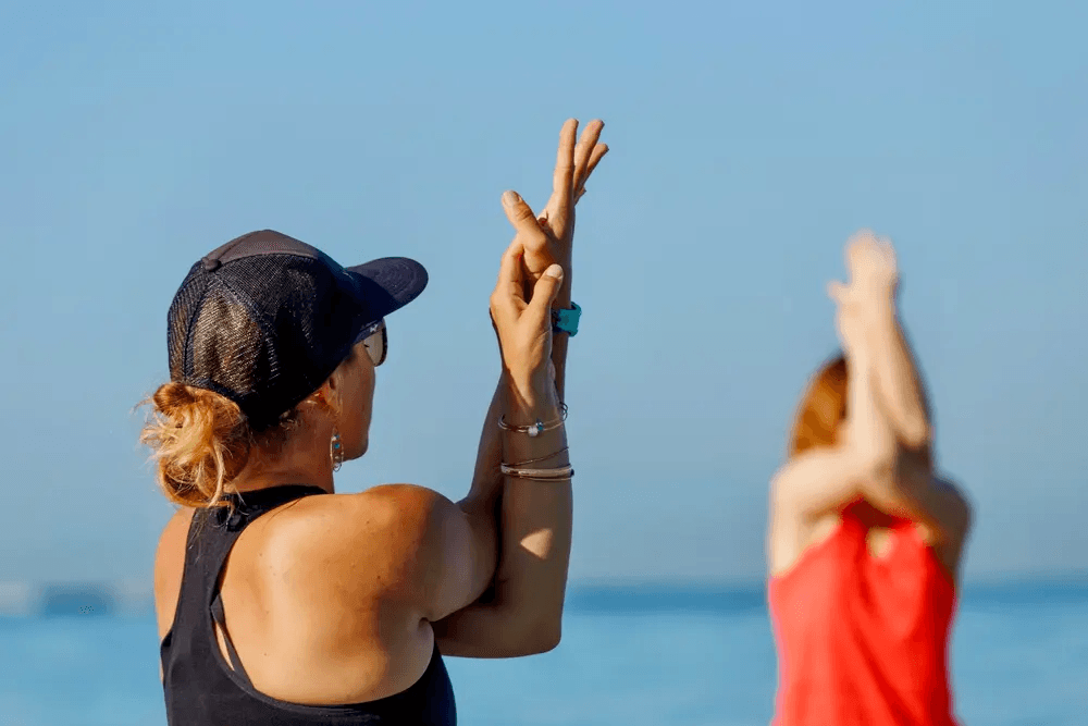 SUP yoga teacher leading a class on the water in Honolulu