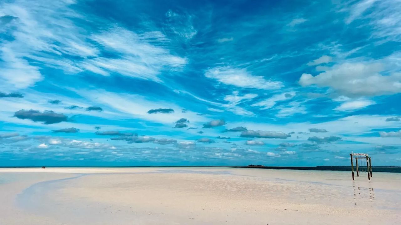 Eleuthera beach with turquoise water, sand, and vivid sky.