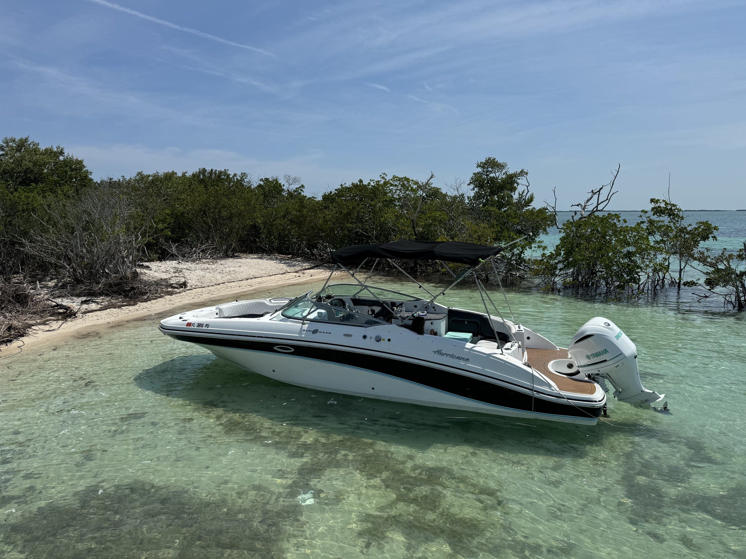 Hurricane deck boat anchored by the mangroves near Key West