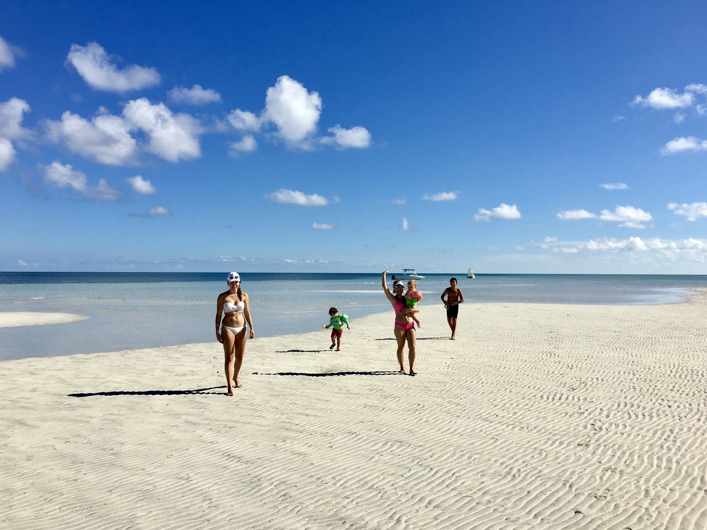 A family walking out onto a Key West sandbar